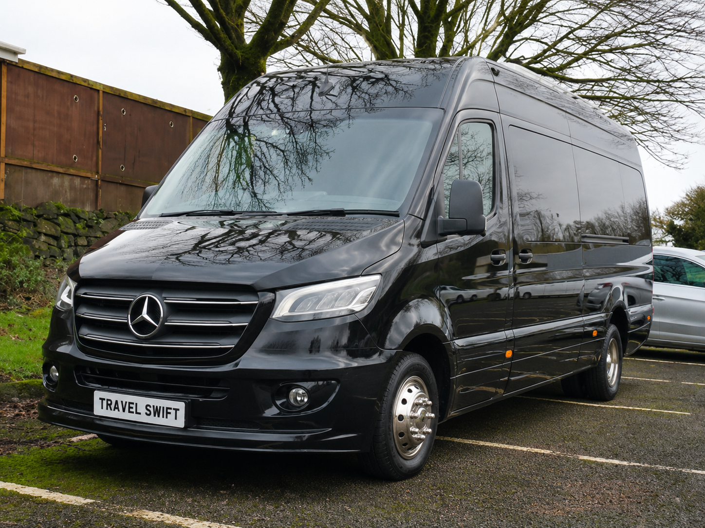 Black executive minibus representing the 10 to 16 seater executive category